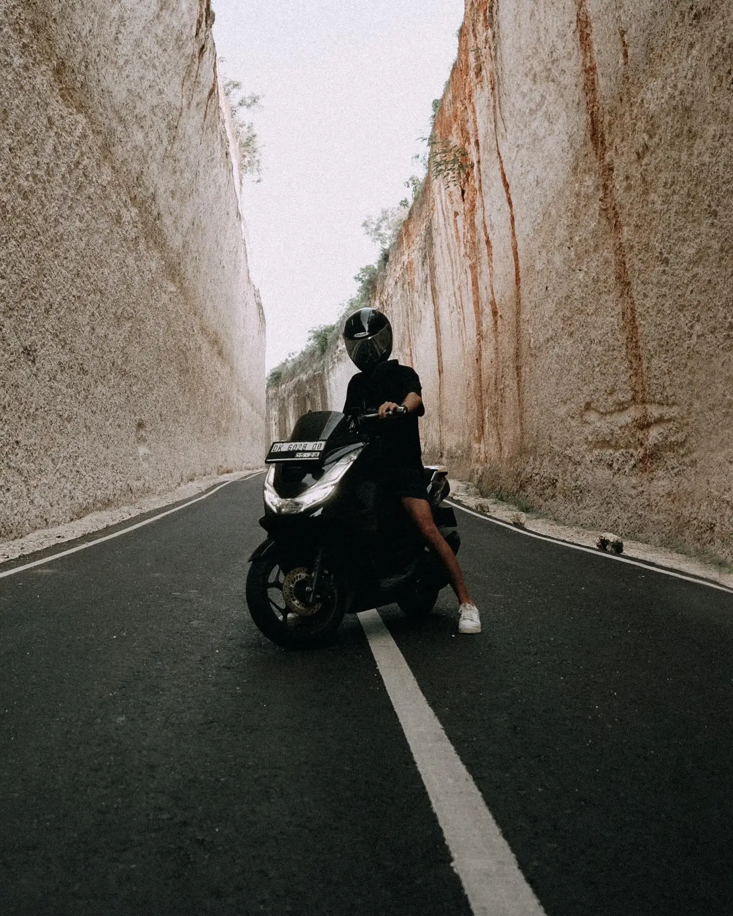 Roman riding a motorcycle on a narrow road